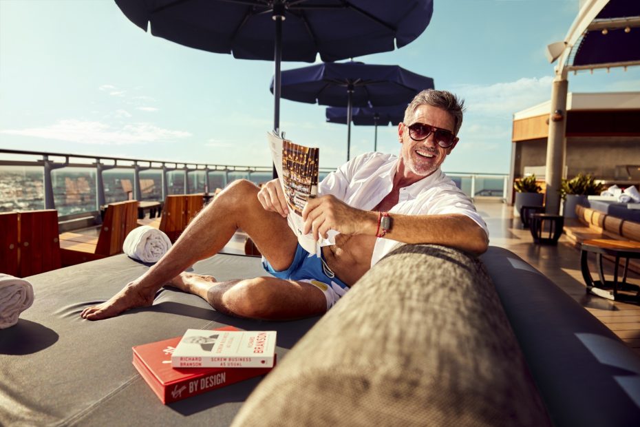 Adults relaxing at the pool on Virgin Voyages adults-only cruise ship
