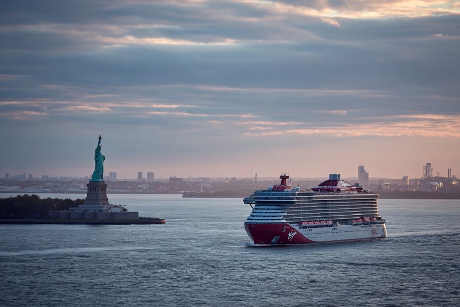 Statue of Liberty with a Virgin Voyages cruise ship departing New York