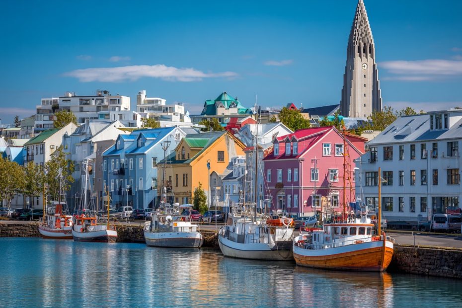 Hallgrimskirkja church towering over colorful buildings in Reykjavik, Iceland