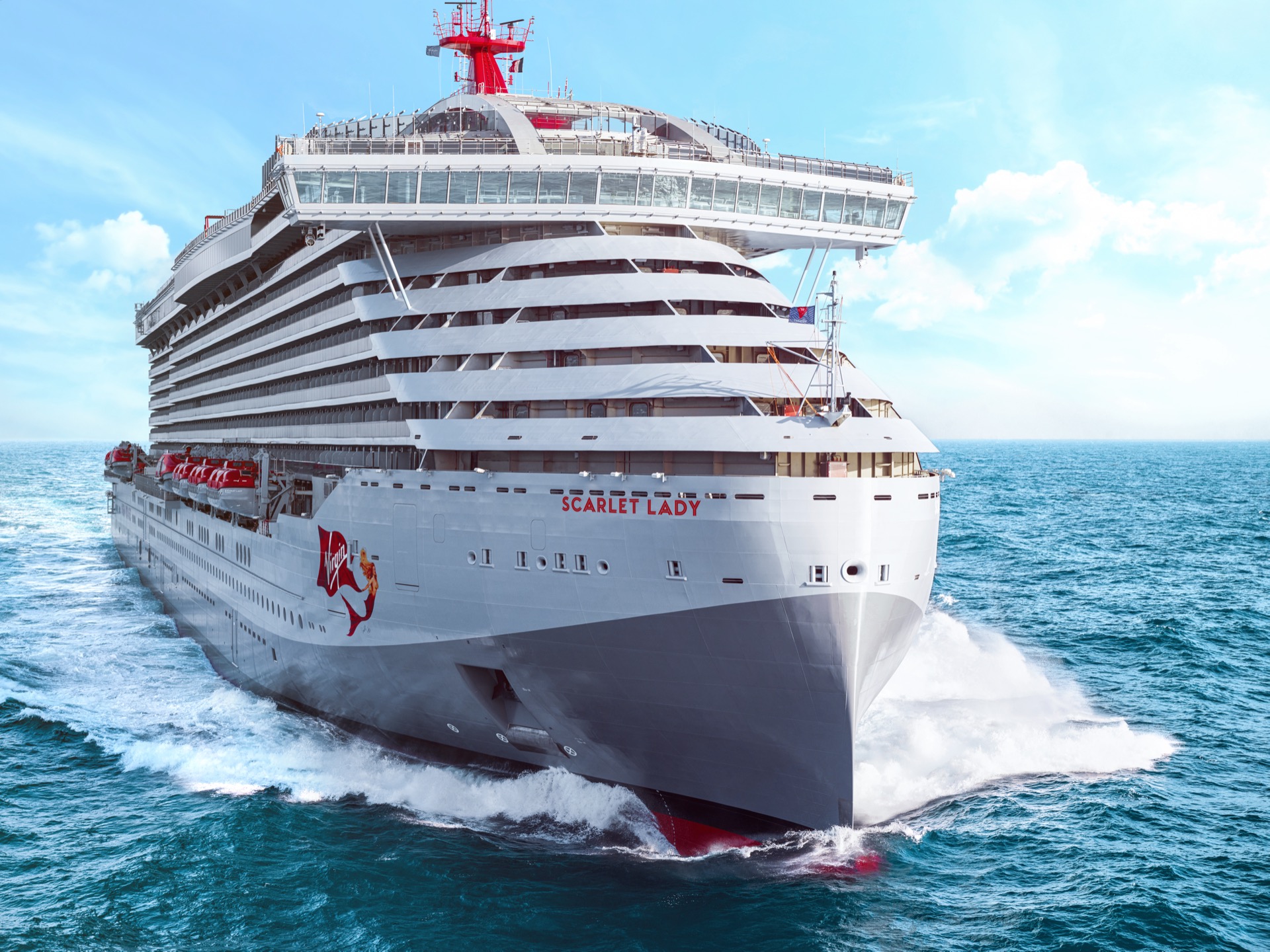 Virgin Voyages ship sailing at sea highlighting the importance of travel insurance