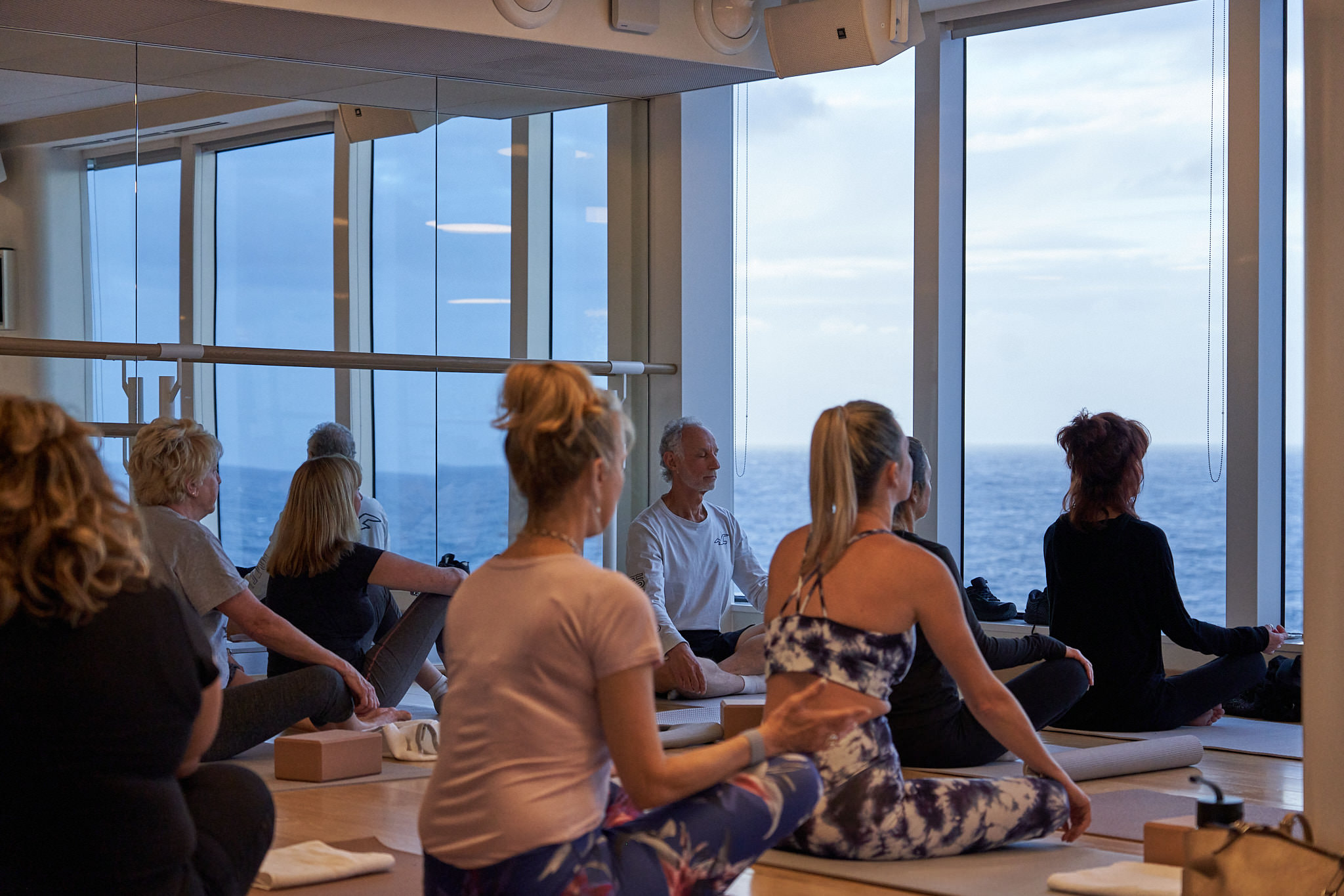 Yoga class on the outdoor deck at sunrise on Virgin Voyages